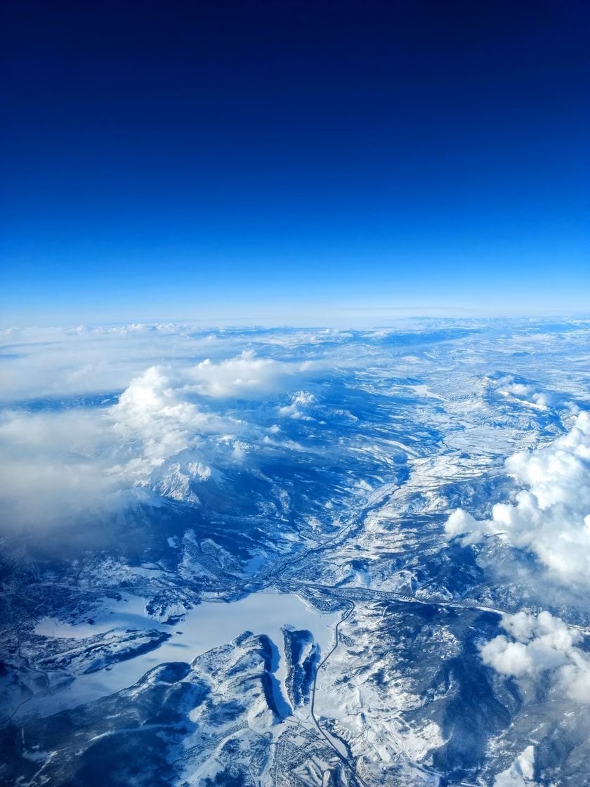 Snow covered mountains and cloud seen from altitude
